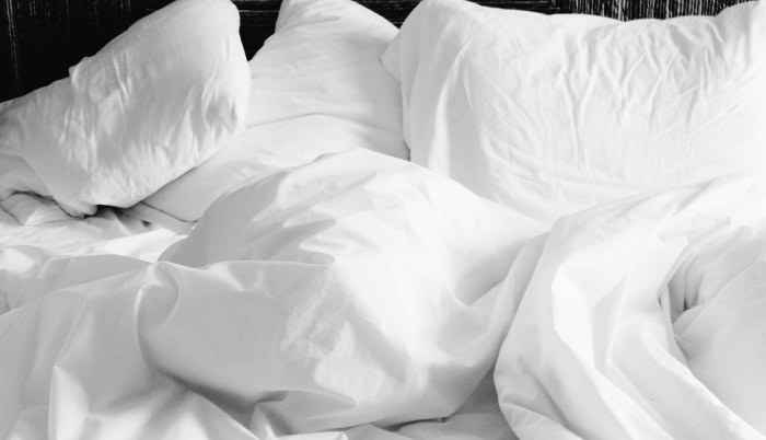 White pillow with white sheets and bedding