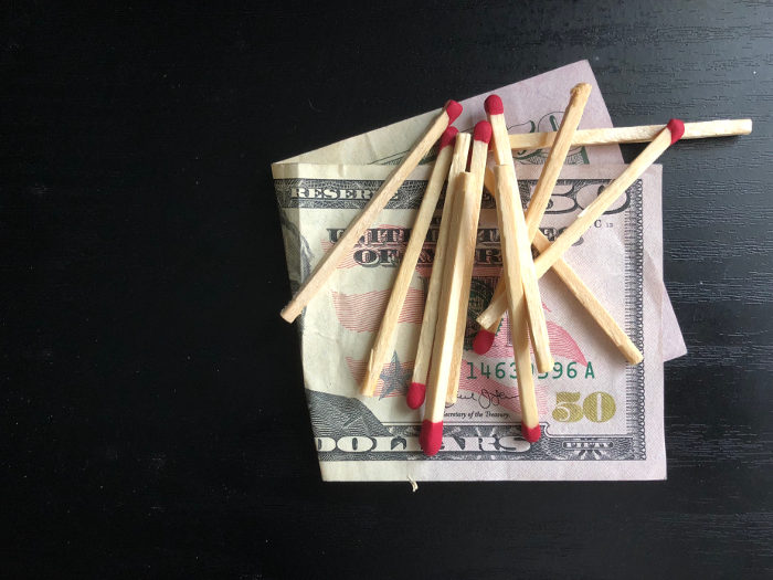 $50 bill covered in matches